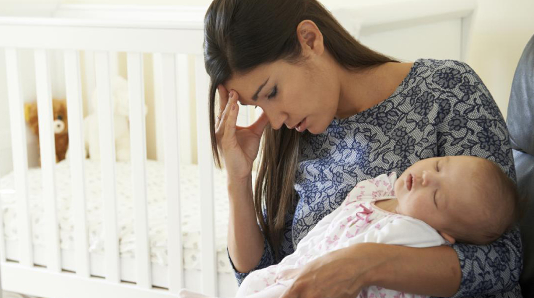 woman-with-postpartum-depression-holding-baby.jpg