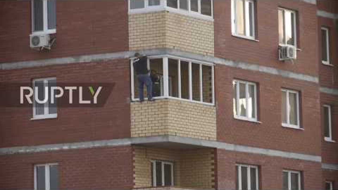 Tyumen man risks life and limb to install 12th floor window with no safety harness