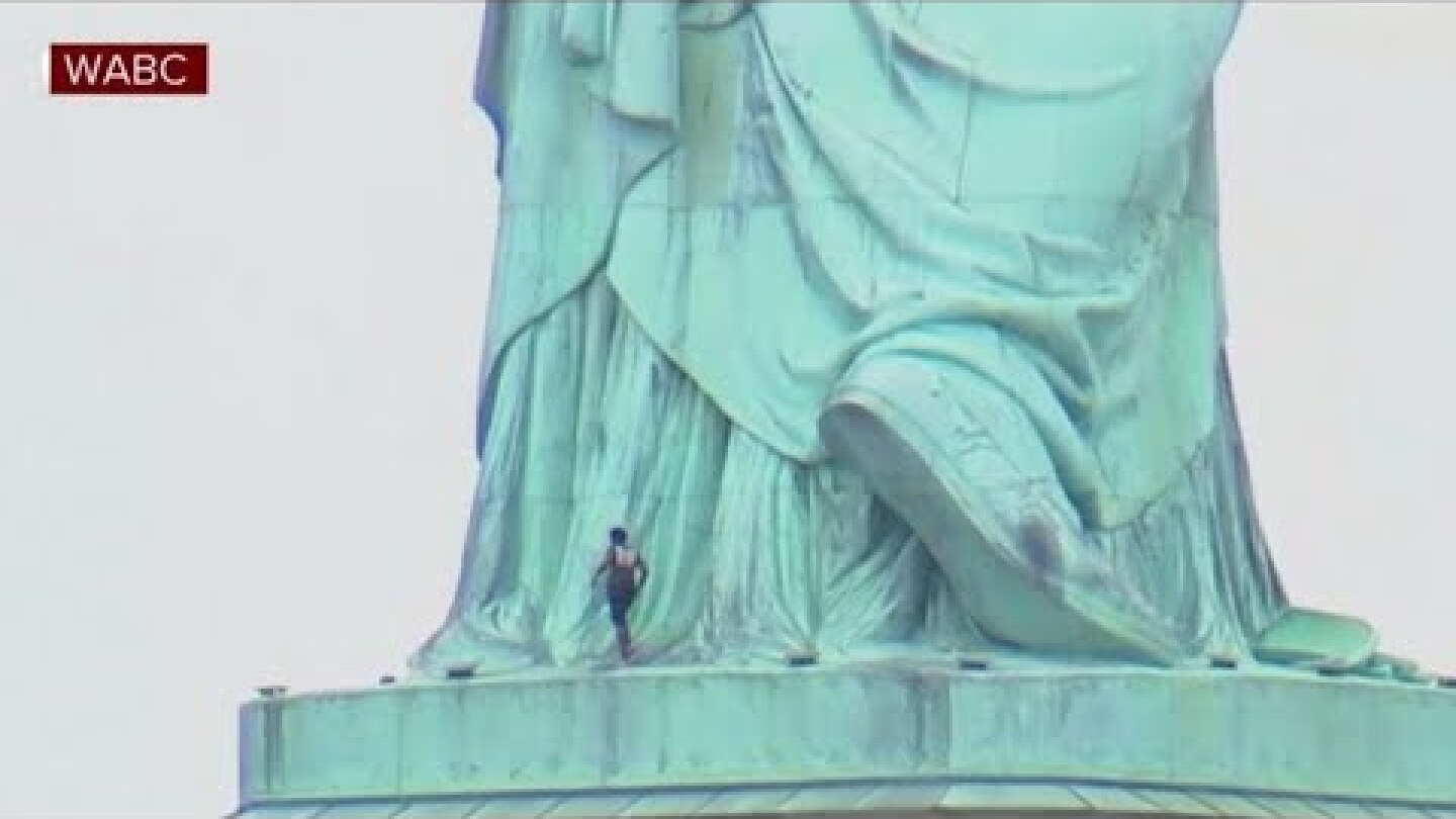 Woman climbing on Statue of Liberty prompts evacuation