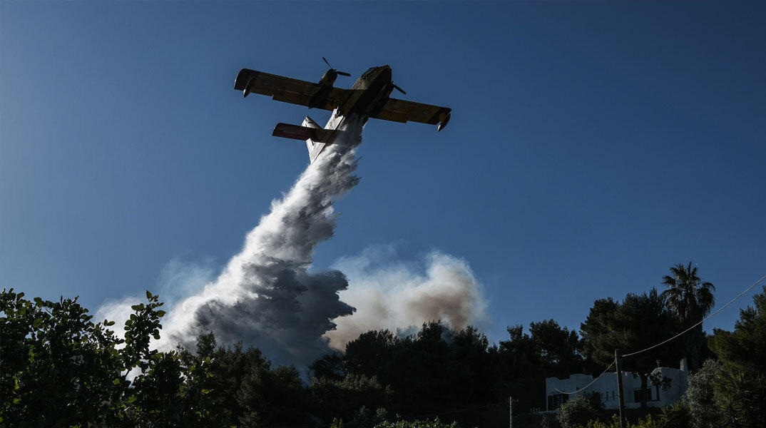 Πυροσβεστικό αεροσκάφος ρίχνει νερό σε δασική πυρκαγιά