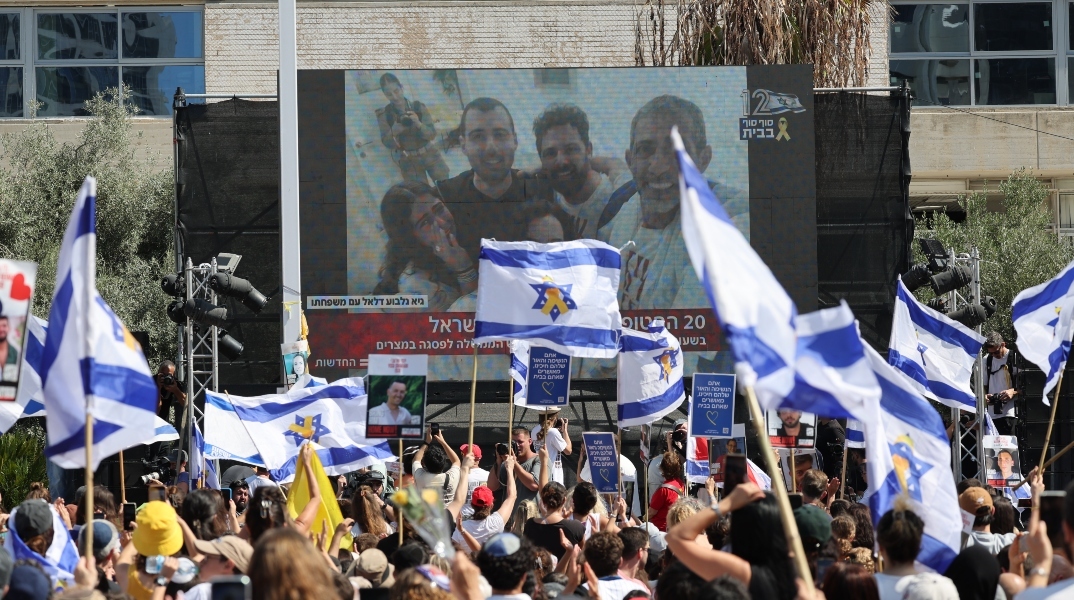 Ισραηλινοί γιορτάζουν την απελευθέρωση ομήρων που κρατούνται από τη Χαμάς καθώς παρακολουθούν από μια οθόνη στην Πλατεία Ομήρων στο Τελ Αβίβ, Ισραήλ, 13 Οκτωβρίου 2025