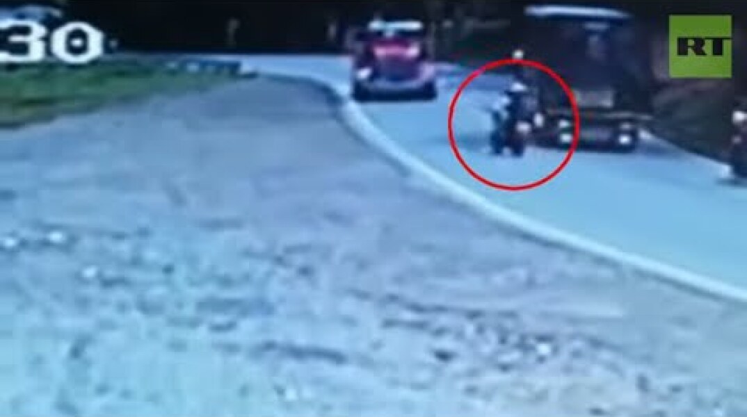 Biker tries to take over truck only to smash into an oncoming truck