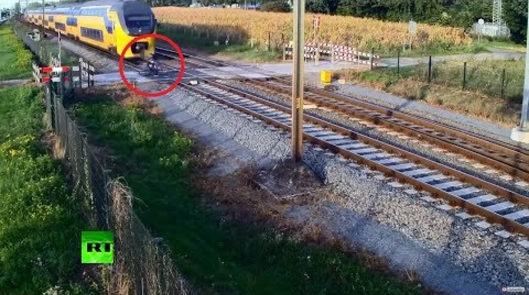 Cheating death: Train sweeps behind Dutch cyclist who didn't see it coming