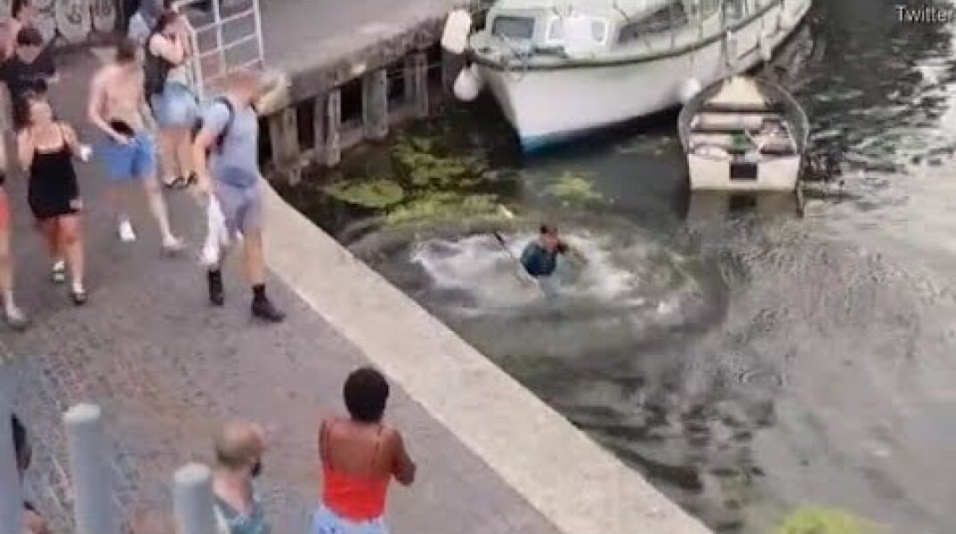 Thug pushes man into canal after he tells-off woman for kicking swan