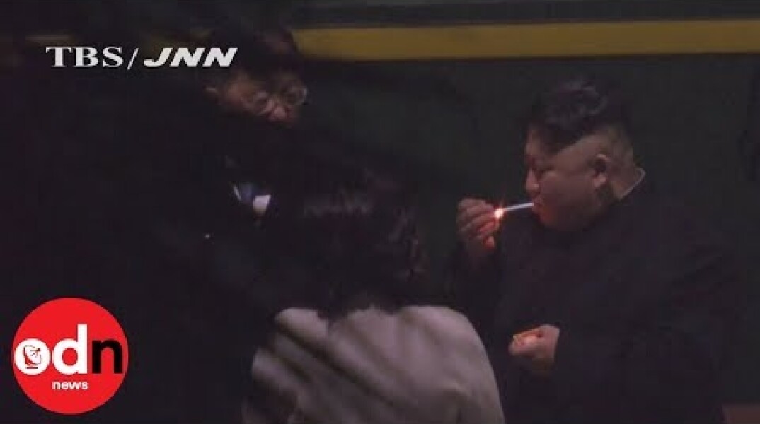Kim Jong-un puffs on cigarette on train station platform in China