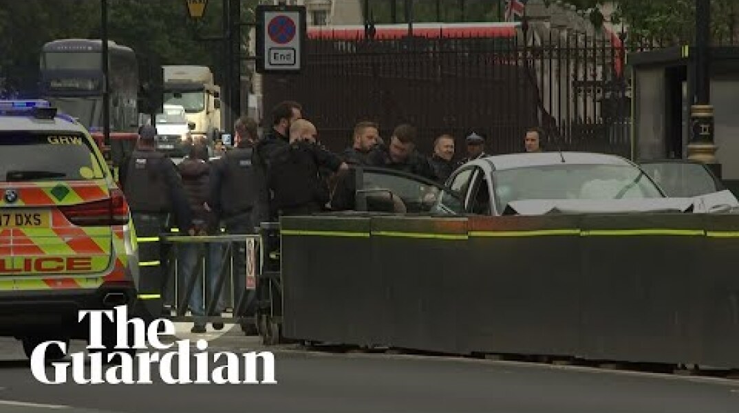 Westminster car crash: handcuffed man taken away by police