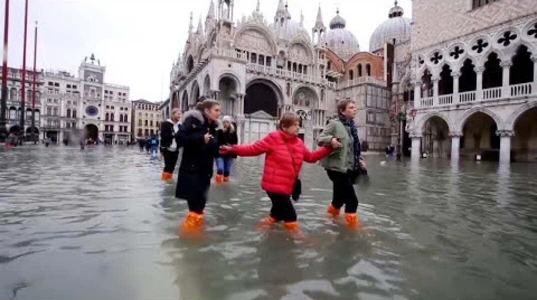 Woman's Luggage Floats Along Flooded Streets of Venice