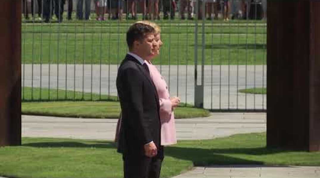 Merkel visibly shaking during ceremony