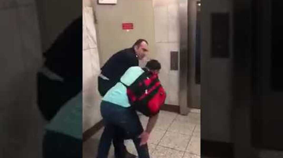 The Police State of Greece: Cop publicly abuses an immigrant selling umbrellas (Syntagma metro)