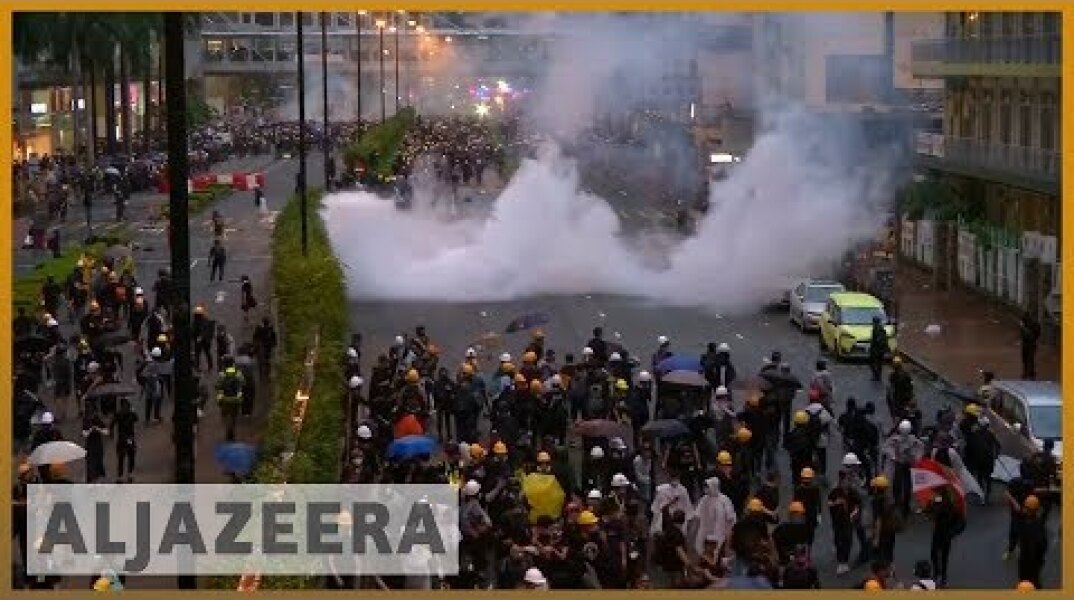 Hong Kong police draw guns, use water cannon in clashes