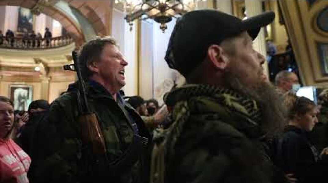 Protesters argue with police inside Michigan Capitol building