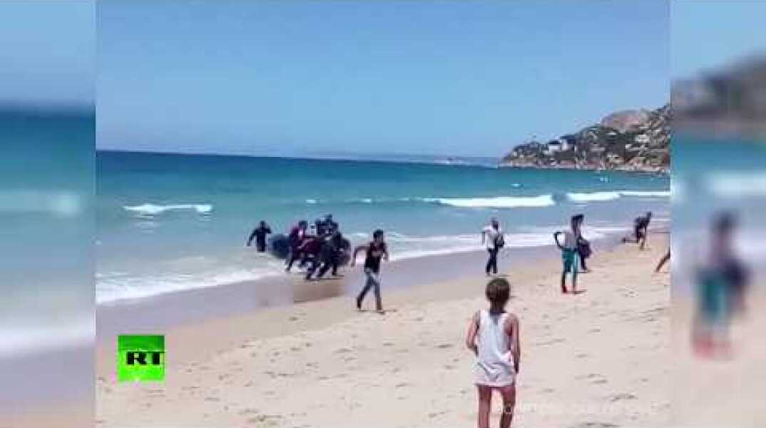 Storm on the beach: Spanish tourists shocked as dinghy full of migrants lands on shore