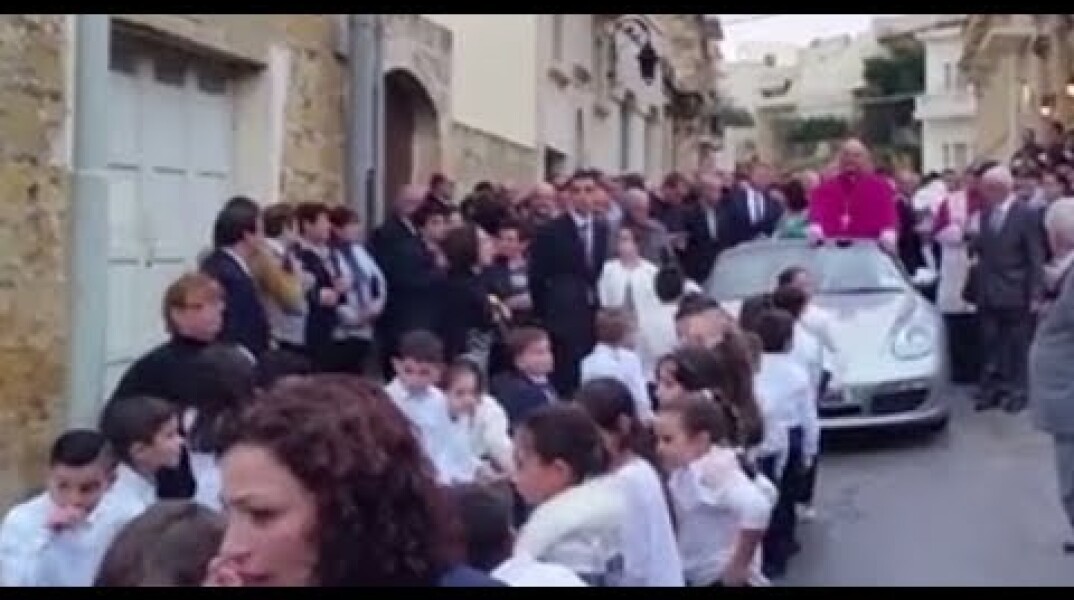 ‘Wrong on so many levels’: Priest in Porsche pulled by children in Malta