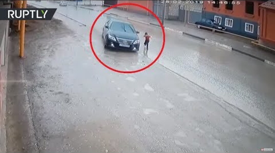 Dramatic video: Driver narrowly avoids hitting boy as he runs across road