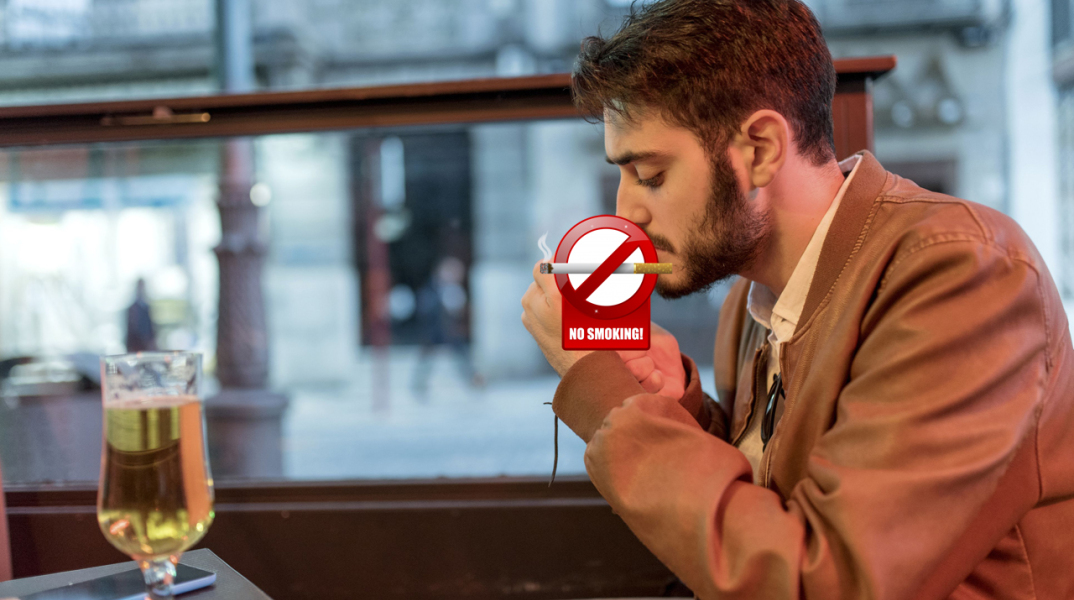 young-man-smoking-a-cigarillo-at-outdoor-bar-688029163-5a5082e2aad52b0036fa01ab_copy.jpg