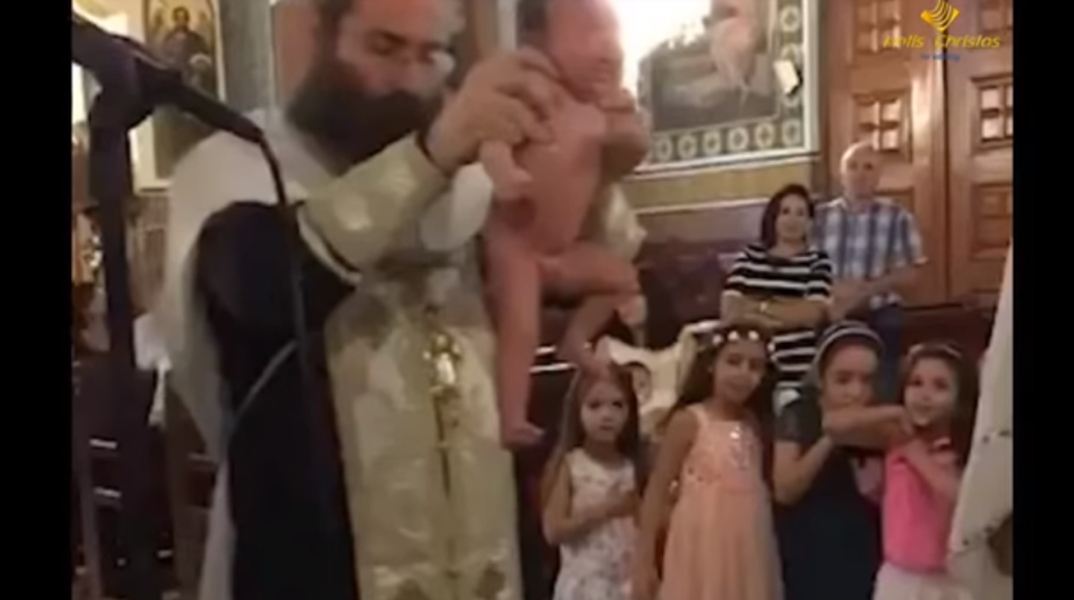 192_greek_orthodox_bishop_repeatedly_dunks_tiny_baby_in_water_in_most_violent_baptism_ever_youtube_copy.jpg
