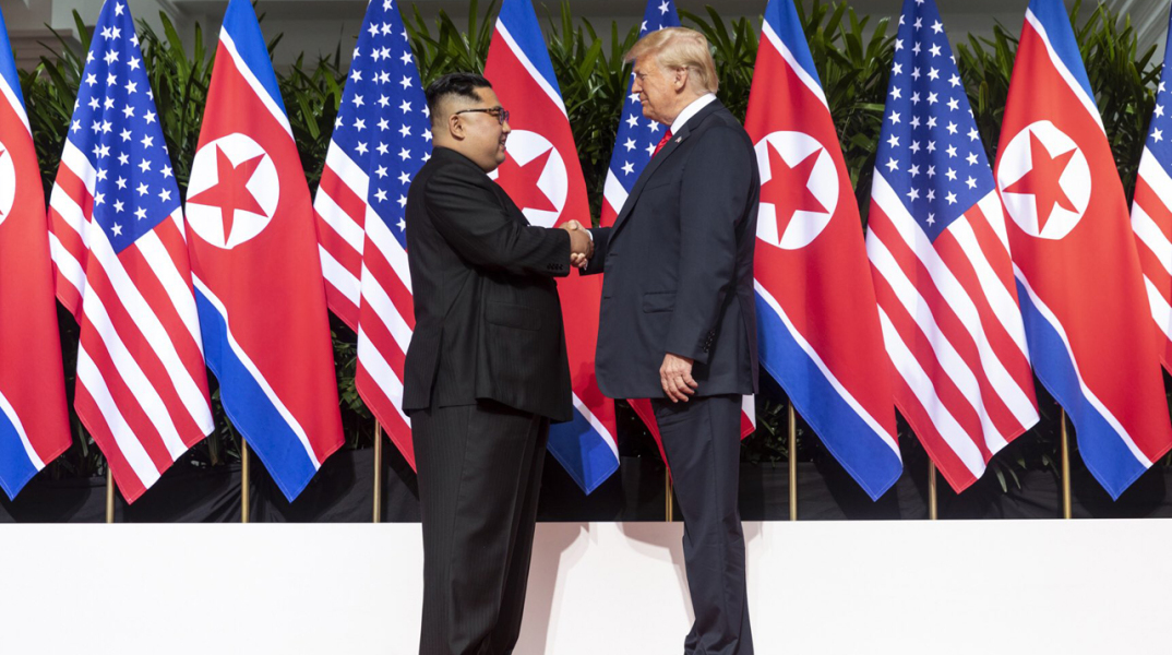 kim_and_trump_shaking_hands_at_the_red_carpet_during_the_dprk-usa_singapore_summit.jpg