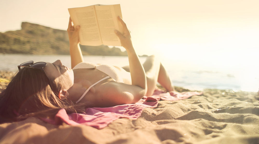 woman-lying-on-beach-reading-book.jpg