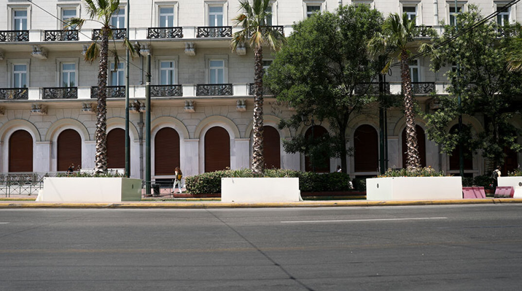 «Μεγάλος Περίπατος της Αθήνας»: Συνεργεία του Δήμου Αθηναίων αφαίρεσαν τα συνθήματα που έγραψαν άγνωστοι στις ζαρντινιέρες με τους φοίνικες στην Πανεπιστημίου