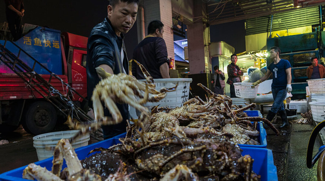 Υπαίθρια αγορά με θαλασσινά στην Κίνα - Καθησυχαστικός ο ΠΟΥ υποστηρίζει ότι δεν υπάρχει κίνδυνος μετάδοσης του κορωνοϊού από τα τρόφιμα και τις συσκευασίες τους