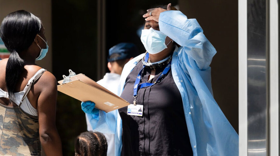 Υγειονομικός υπάλληλος με προστατευτική μάσκα έξω από διαγνωστικό κέντρο για τον κορωνοϊό στη Νέα Υόρκη