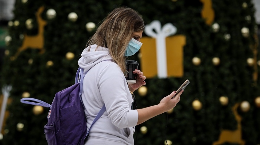 Γυναίκα με μάσκα στη στολισμένη Ομόνοια 