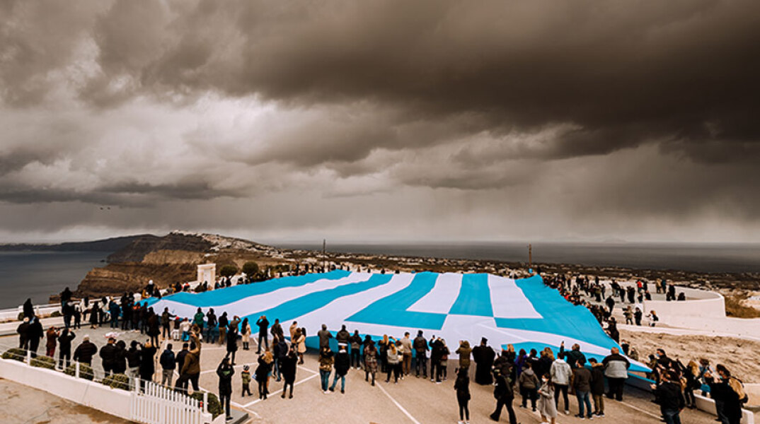 Στη Σαντορίνη άπλωσαν μια τεράστια ελληνική σημαία για την 25η Μαρτίου και τα 200 χρόνια από την Ελληνική Επανάσταση