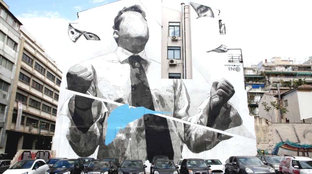 Γκράφιτι του διάσημου street writer "iNo" για ασθενείς με ηπατίτιδα Β και C στο πλάϊ του κτιρίου του ΕΟΠΥΥ, στη διασταύρωση των οδών Πειραιώς και Δεληγιώργη, στην Ομόνοια © ΑΠΕ / Αλέξανδρος Μπελτές
