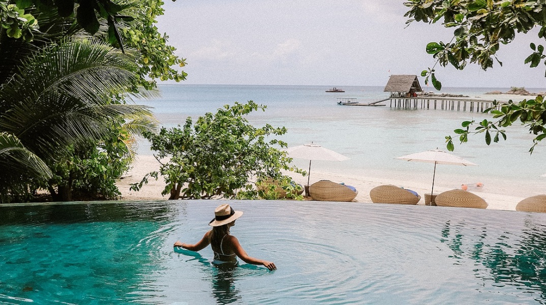 Μια γυναίκα απολαμβάνει το μπάνιο της σε μια πισίνα.