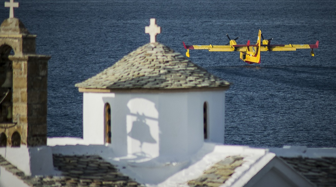 Πυροσβεστικό καναντέρ που πετά πάνω από εκκλησία