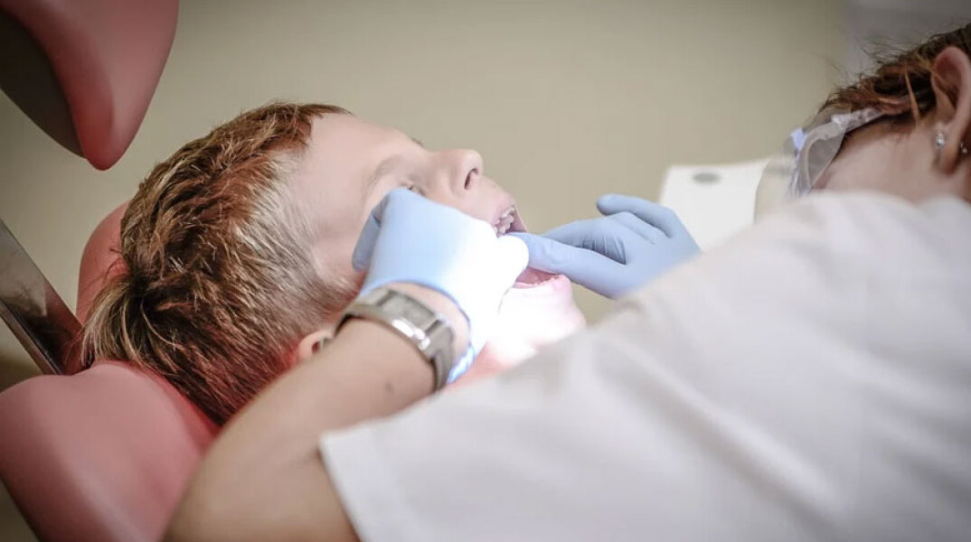 Οδοντίατρος εξετάζει τα δόντια παιδιού (ΦΩΤΟ ΑΡΧΕΙΟΥ) - Δωρεάν ιατρικές εξετάσεις σε παιδιά από τον Δήμο Αθηναίων για τη νέα σχολική χρονιά