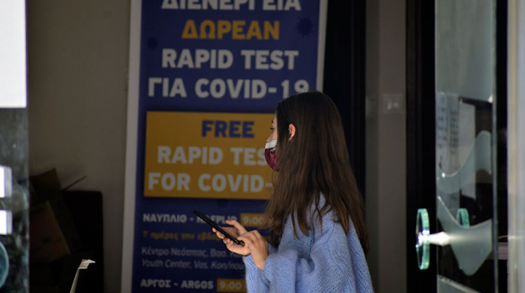 Κοπέλα με μάσκα για κορωνοϊό σε σημείο όπου διενεργούνται rapid test από τον ΕΟΔΥ
