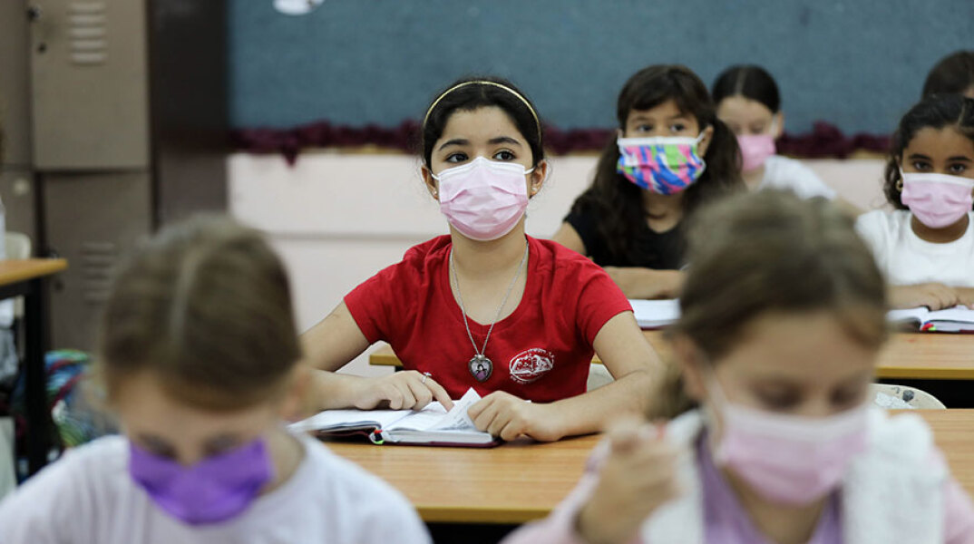 Παιδιά με μάσκα για τον κορωνοϊό σε σχολείο