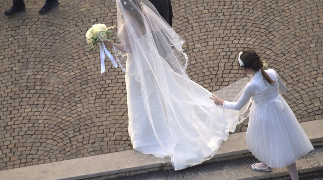 Γάμος - Παρανυφάκι κρατά την ουρά νυφικού