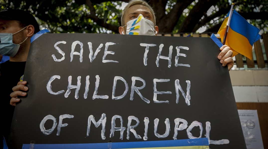 Μήνυμα γραμμένο στα αγγλικά και σε πίνακα στα χρώματα της Ουκρανίας για τη σωτηρία των παιδιών στη Μαριούπολη της Ουκρανίας