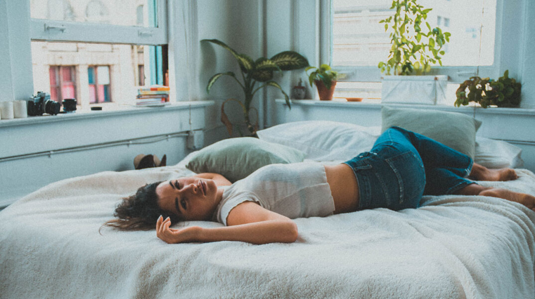 Γυναικα ξαπλωμένη με τα ρούχα σε κρεβάτι