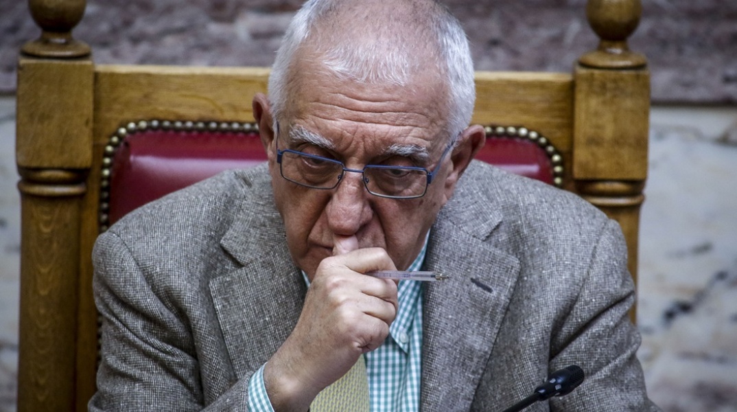 O Νικήτας Κακλαμάνης στο έδρανο του προεδρείου της Βουλής κρατά ένα στιλό και το πρόσωπό του