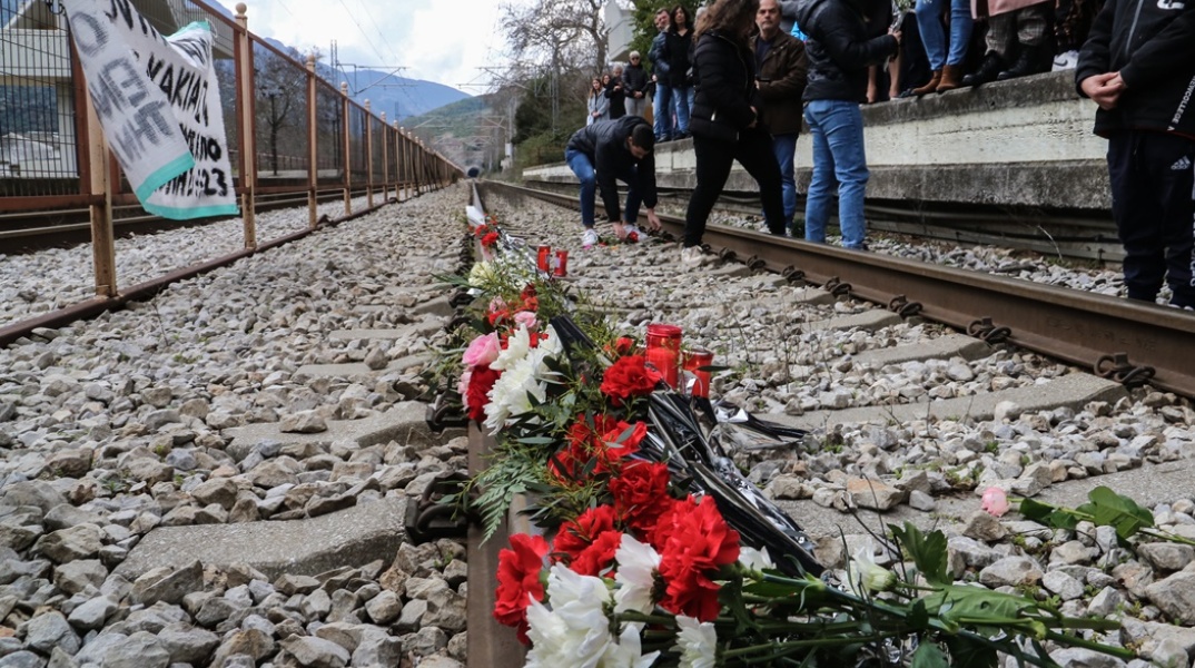 Λίγα λουλούδια στις ράγες του σιδηροδρομικού σταθμού της Λάρισας για τα 57 θύματα της σιδηροδρομικής τραγωδίας στα Τέμπη