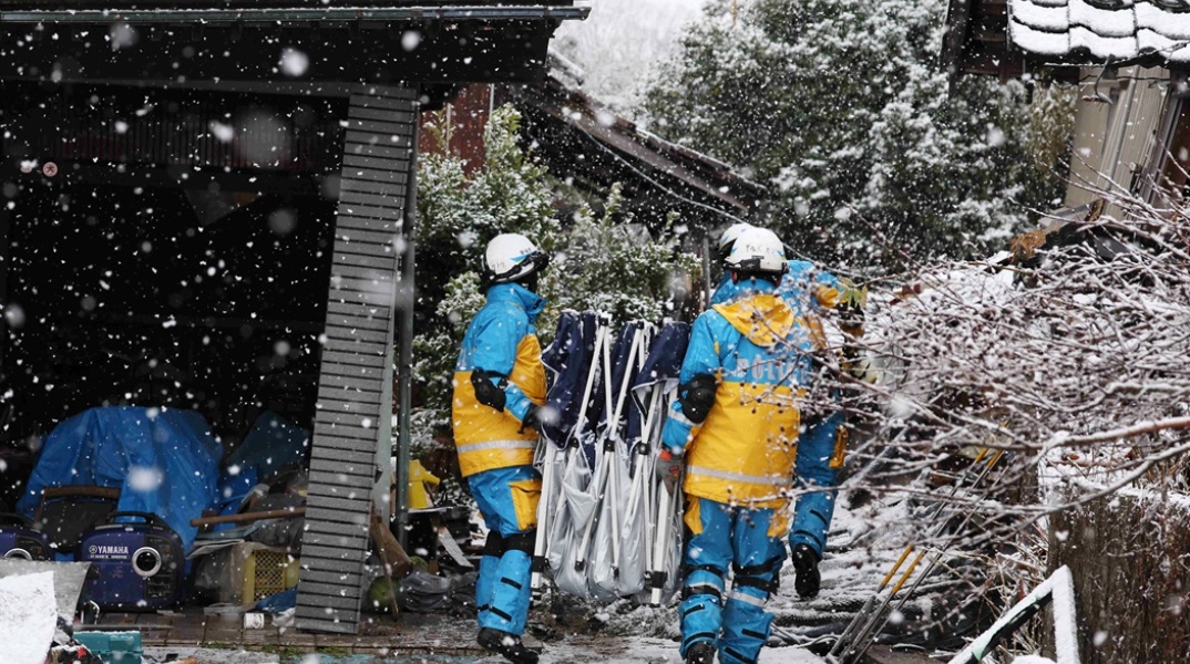 Διασώστες επιχειρούν εν μέσω χιονοπτώσεων για επιζώντες στα ερείπια μετά τον φονικό σεισμό που έπληξε την Πρωτοχρονιά την Ιαπωνία