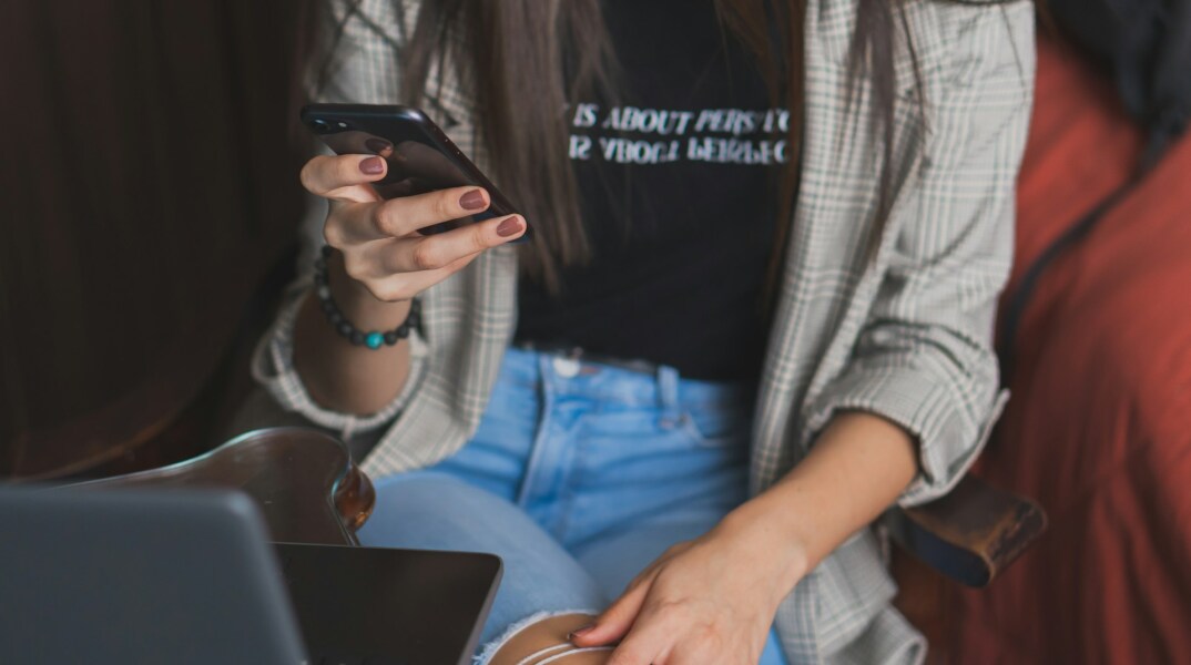 Γυναίκα διαβάζει sms που έλαβε στο κινητό της