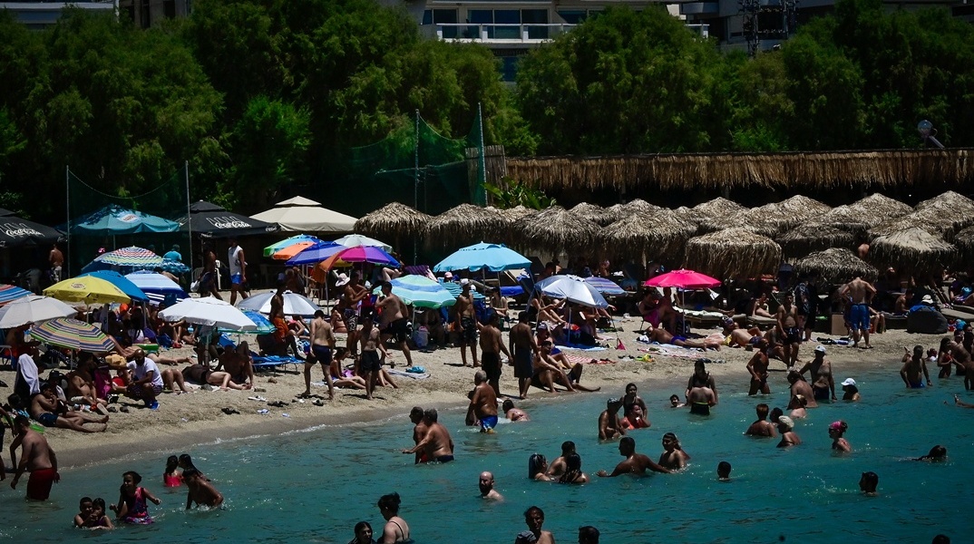 Λούομενοι σε παραλία όπου αναζήτησαν λίγες στιγμές δροσιάς εν μέσω καύσωνα