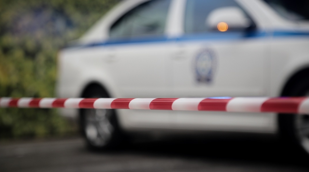 Περιπολικό της ΕΛ.ΑΣ. με κορδέλα με την οποία έχει αποκλειστεί σημείο