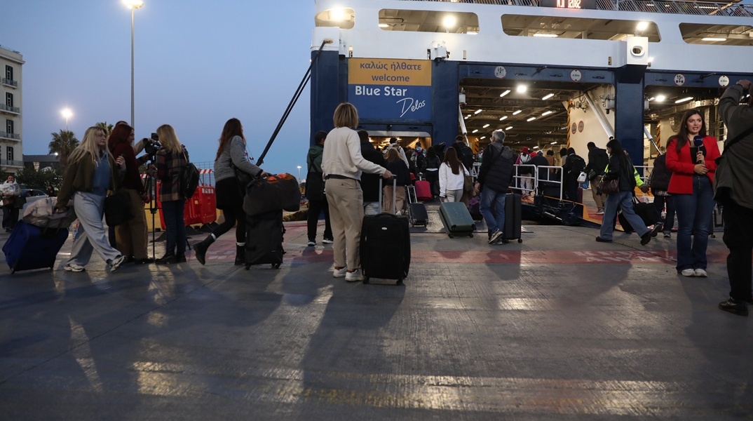 Εκδρομείς με τις βαλίτσες του επιβιβάζονται σε πλοίο