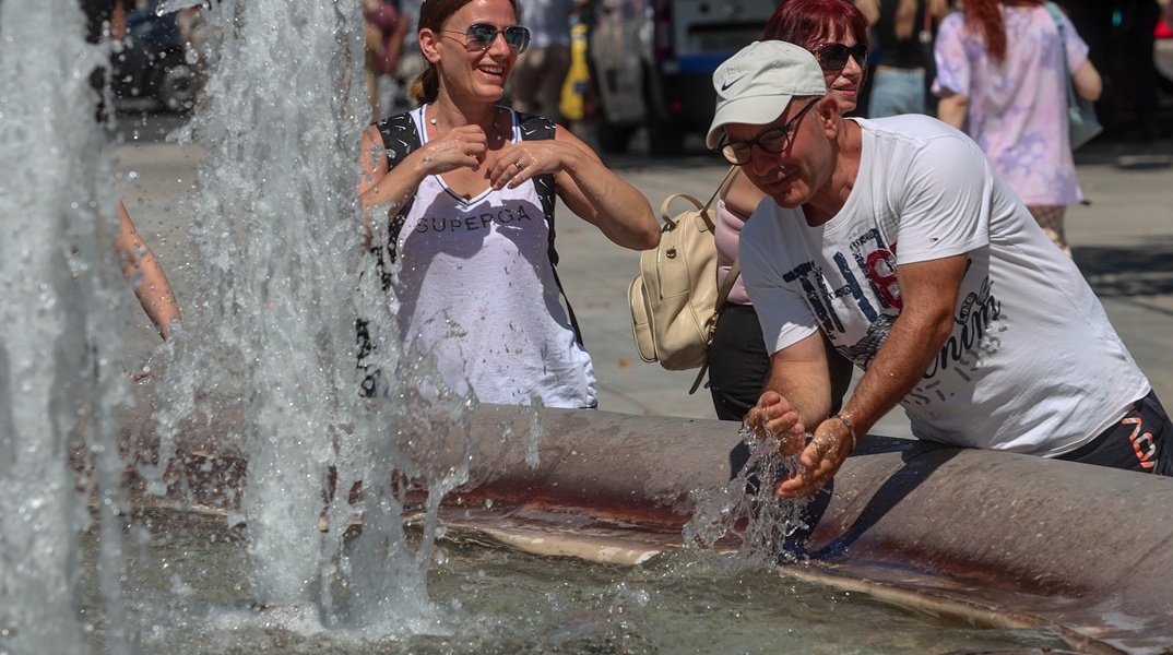 Πολίτες δροσίζονται σε σιντριβάνι