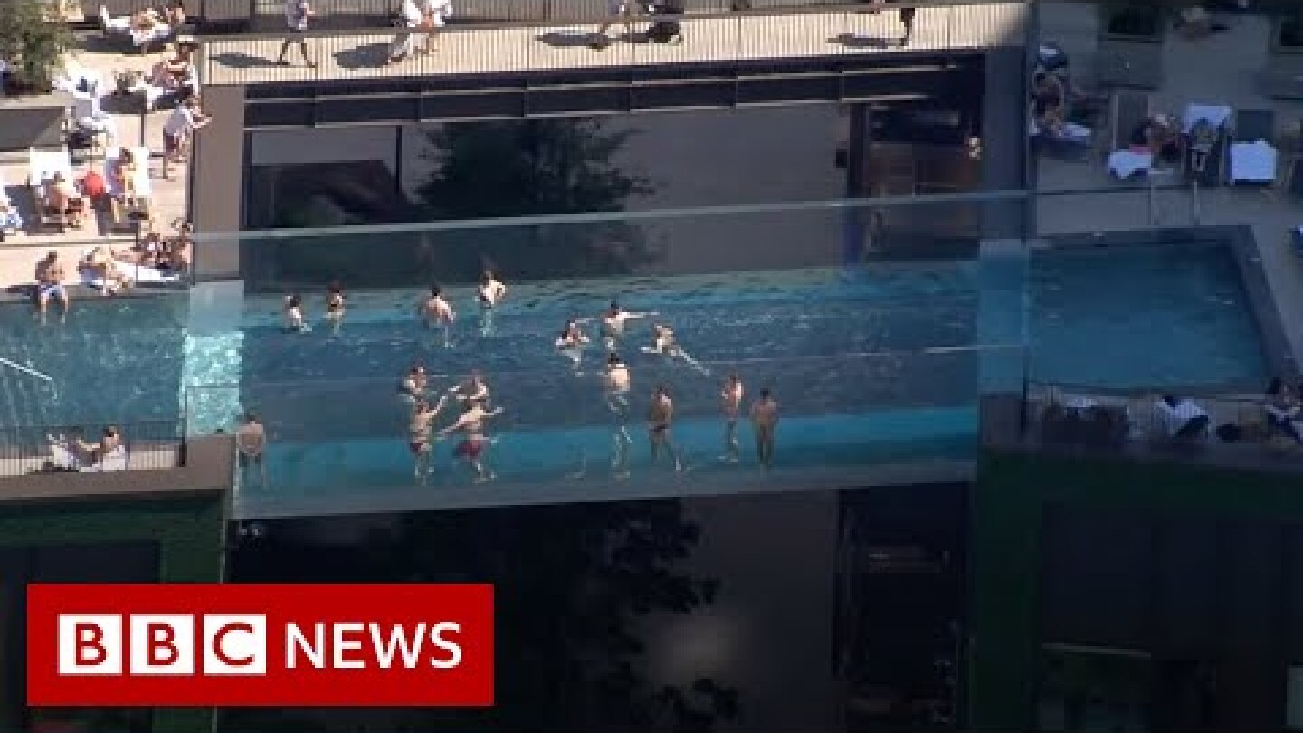 World's first 'floating' pool suspended between London tower blocks - BBC News