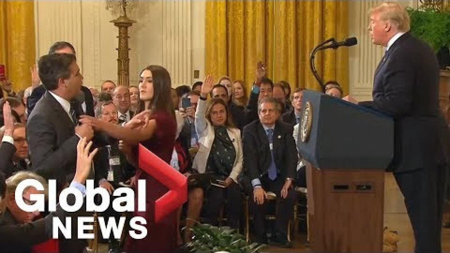 White House aide grabs mic from CNN's Acosta during heated exchange with Trump