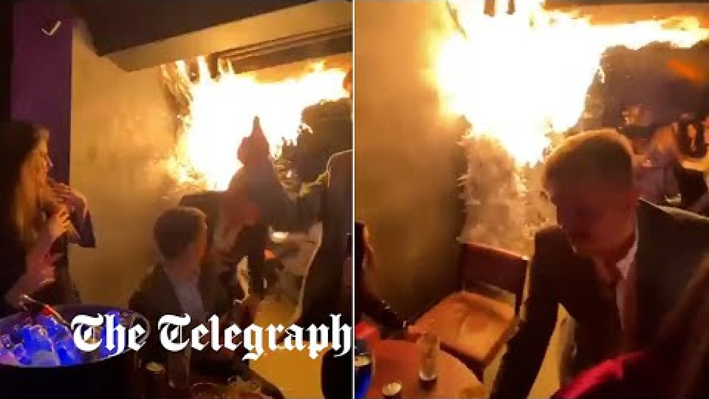 Moment panicked diners flee London restaurant after sparkler set fire to Christmas tree