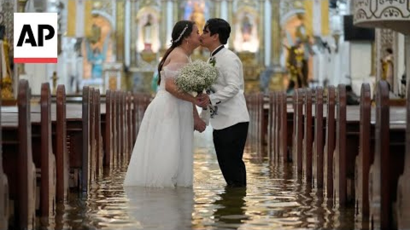 Couple marries in flooded Philippines church after Typhoon Wipha intensifies rains