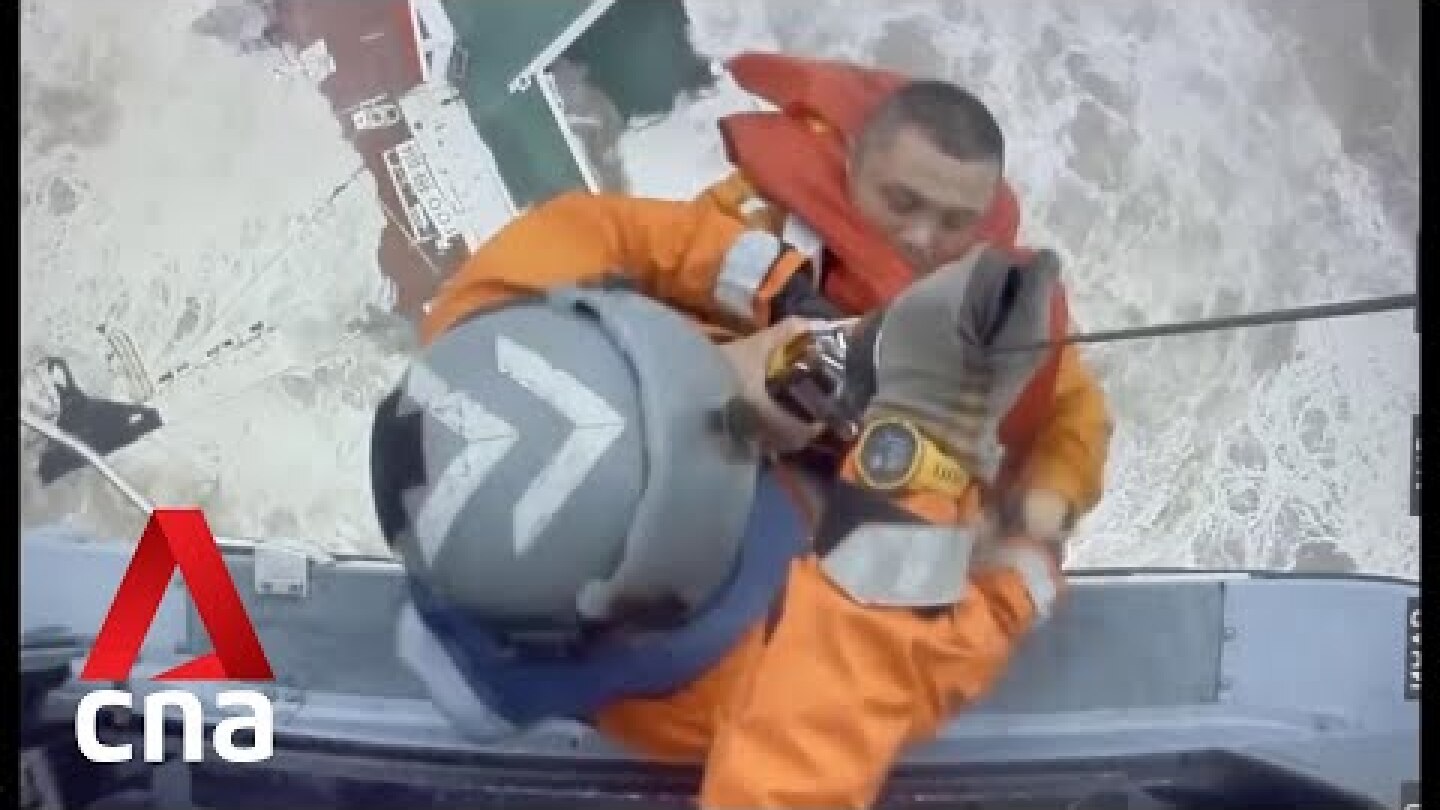 Rescuers save a man from a shipwreck off Hong Kong after Typhoon Chaba
