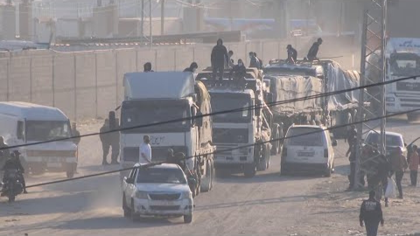 Aid trucks enter Gaza through the Rafah crossing, escorted by Hamas police